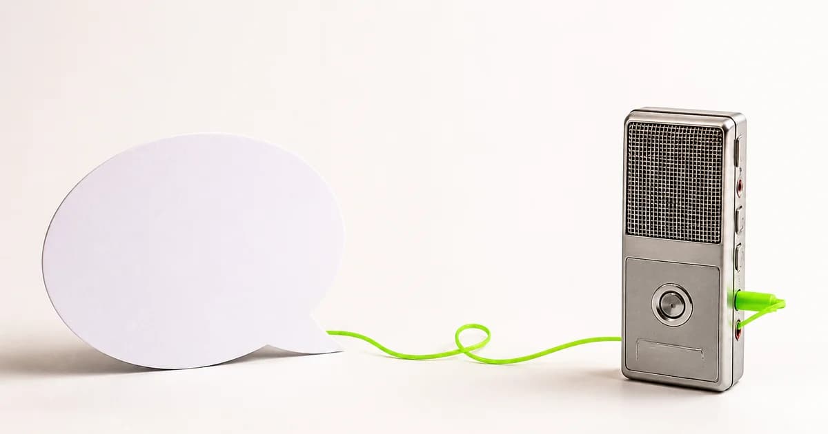 Paper speech bubble connected by a lime cable to a voice recorder